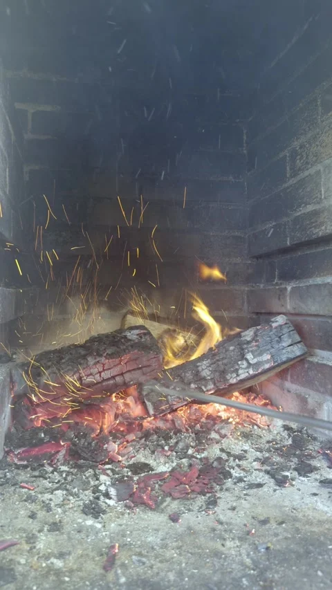 Firewood burning in rustic brick fireplace Stock Footage 307952858