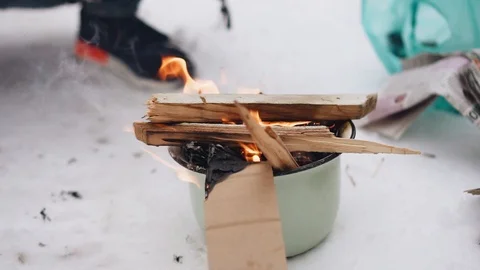 Firewood is burning in a small pot standing on the ground. Close up Stock Footage 123792923