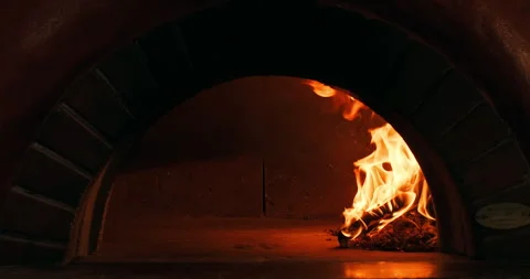 Firewood burning in a stone oven to bake pizza, pide or bread. Burning fire in Stock Footage 260751880