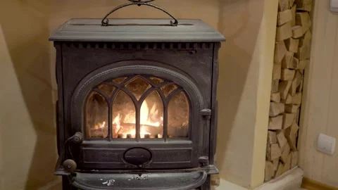 Firewood by the fireplace. Fire Burning In Fireplace Of Old Cafe Video stock 189325834