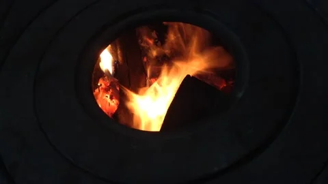 Firewood Flame of Fire Actively burning in the Round Circle of a Stove Hole Stock Footage 167971034