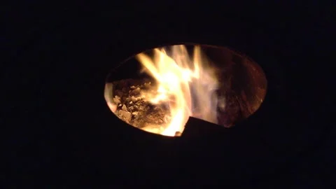 Firewood Flame of Fire Actively burning in the Round Circle of a Dark Stove Hole Stock Footage 167971057