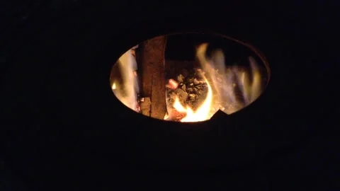Firewood Flame of Fire Actively burning in the Round Circle of Dark Stove Hole 1 Video stock 167971060