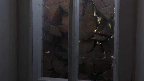 Firewood outside the window, stocked drones for the winter, old window Stock Footage 220488660