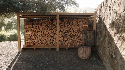 Firewood stack for home heating and winter preparation Stock Footage 345848246