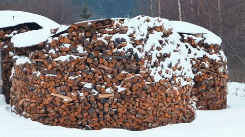 Firewood in a Stack Under Snow Stock Footage 64748861