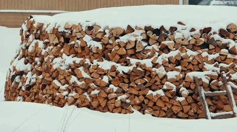 Firewood in a Stack Under Snow Stock Footage 64750141
