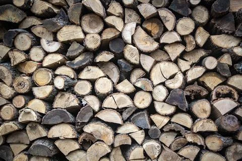 Firewood stacked in rows as texture background Stock Photos