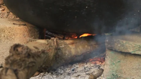 Firewoods flame under huge black pot Stock Footage 86172608