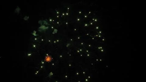 Firework abstract blossoms explode with sparkling lights at nighttime holiday Stock Photos