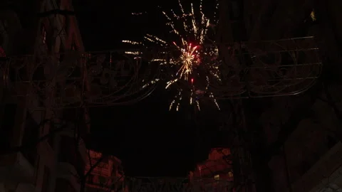 Firework bursting over Fallas street arch in Valencia during festival night Stock Footage 336724115