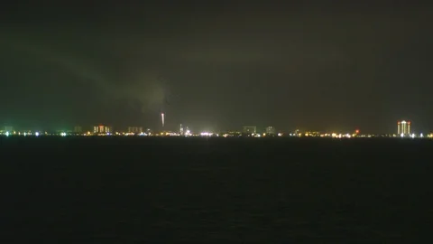 Firework display over ocean water Stock Footage 104881733