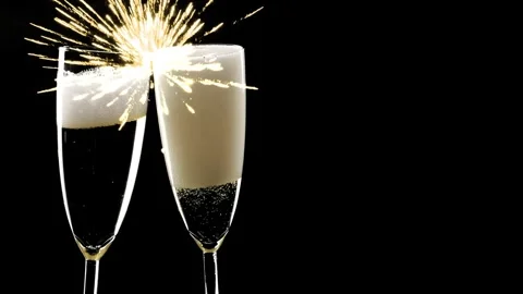 Firework during clink of two champagne flutes isolated on black 動画素材 281166518