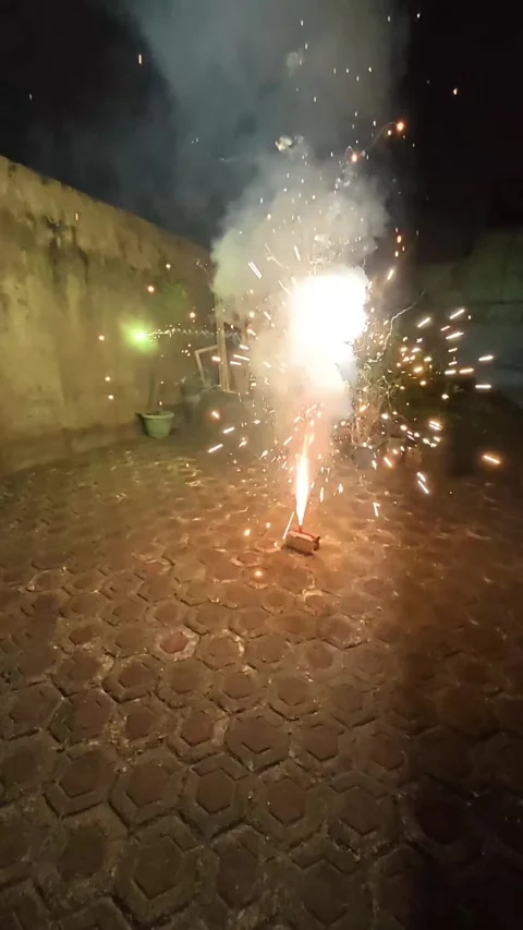 Firework explodes at night, casting bright sparks. Stock Footage 339398416