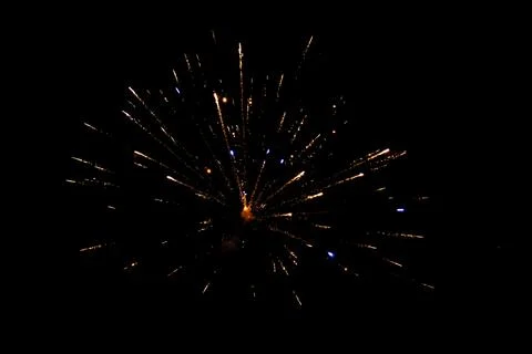 Firework exploding in the dark night sky to celebrate the new year. Colorful  Stock Photos