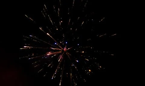 Firework exploding in the dark night sky to celebrate the new year. Colorful  Stock Photos