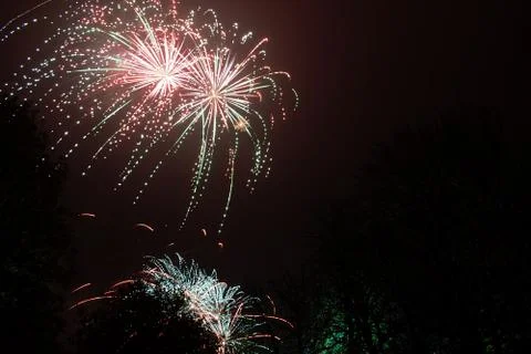 Firework exploding, in the night sky Stock Photos