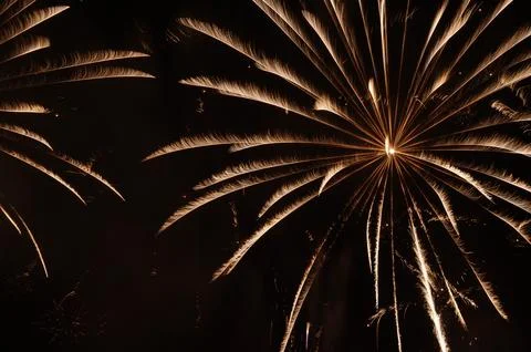 Firework explosions in dark night sky Stock Photos