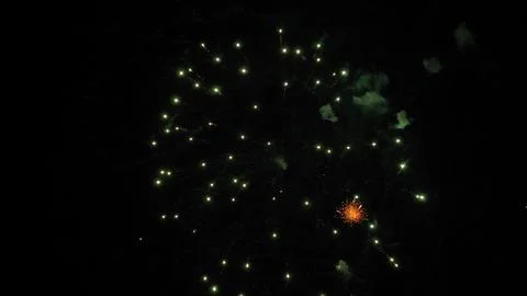 Firework explosions with glowing traces and stars in sky at nighttime holiday Stock Photos