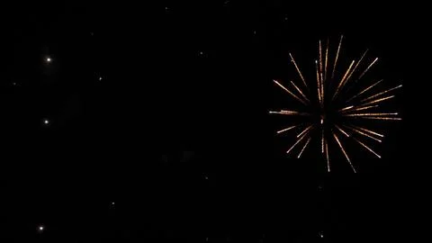 Firework explosions with glowing traces and stars in sky at nighttime holiday Stock Photos