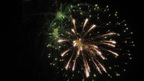 Firework explosions illuminate darkness with sparkling stars fountains Stock Photos