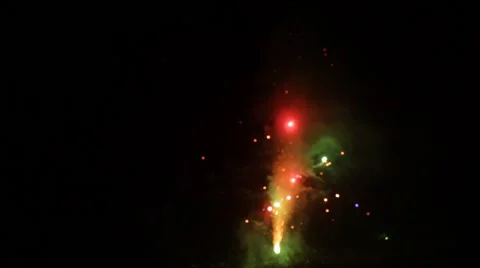 Firework goes from red and green to white sparkle Stock Footage 40210283