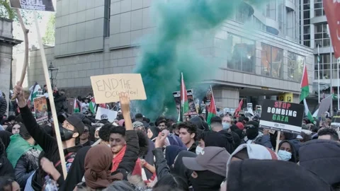 Firework let off next to flare in crowds at free Palestine protest, London Stock Footage 155503306
