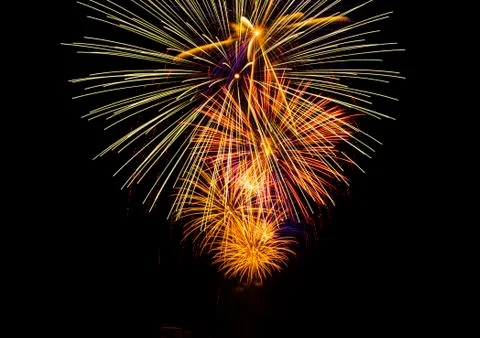 Firework on a long exposure on a dark background. Stock Photos