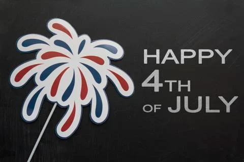 Firework props on blackboard with the text Happy 4th of July Stock Photos