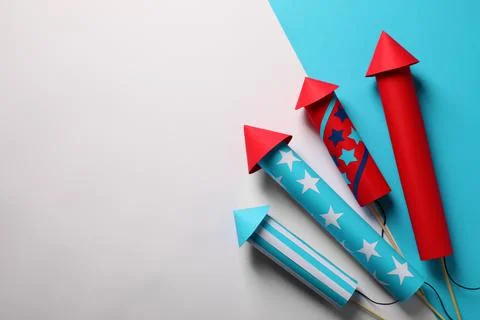 Firework rockets on color background, flat lay with space for text. Festive d Stock Photos