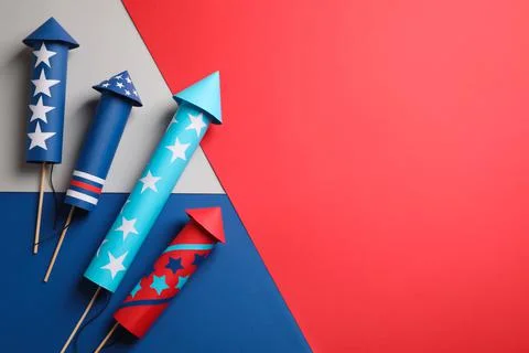 Firework rockets on color background, flat lay with space for text. Festive d Stock Photos