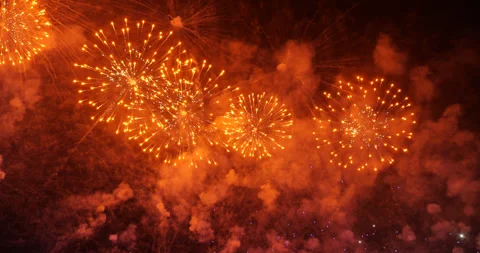 Firework rockets fly up with sparks and then explode to vibrant red orbs, slowmo 库存影片 326377069