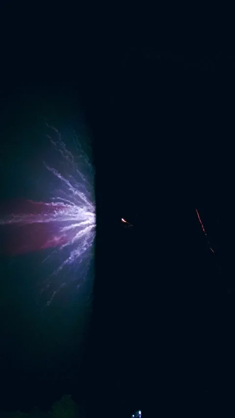 Firework shooting up to the dark night sky before exploding and revealing Stock Footage 319517590