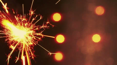 Firework sparkler burning on bokeh light background, greeting Stock Footage 57481315