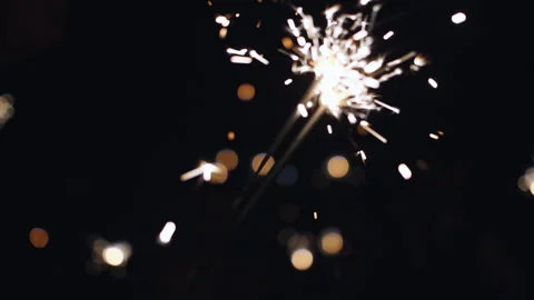 Firework sparkler burning with lights in background Stock Footage 116895243