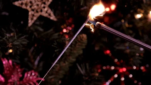 Firework sparkler burning with lights in background Video stock 123473568