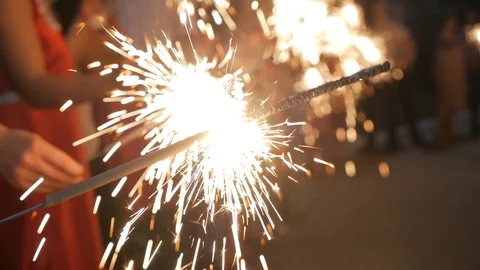 Firework sparkler burning with lights in background Video stock 123646949