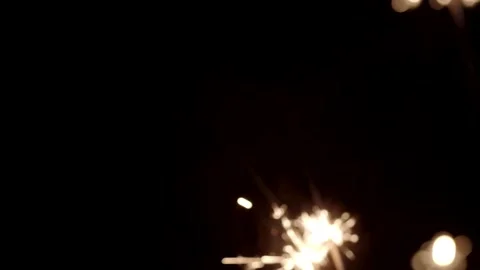 Firework sparkler burning with lights in background. Stock Footage 166703880