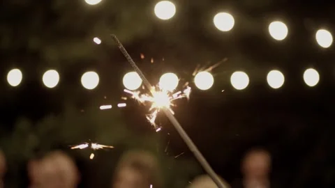 Firework sparkler burning with lights in background. Stock Footage 257120600