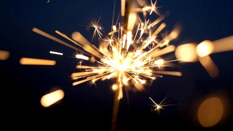 Firework sparkler burning over dark background. Slow motion shot Stock Footage 115416051