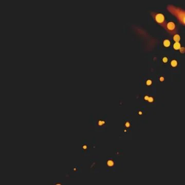 A firework texture with a black background and a yellow light 写真素材