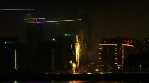 Fireworks are set off next to tall buildings to celebrate the end of the ye.. Stock Footage 260360214