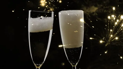 Fireworks around two touching champagne glasses isolated on black Stock Footage 281166512