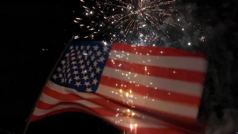 Fireworks behind flag Stock Footage 157240325