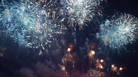 Fireworks bursting and floating in the dark night sky Stock Footage 314497103