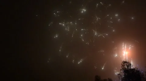 Fireworks cracking against a black sky in the night Stock Footage 49737248