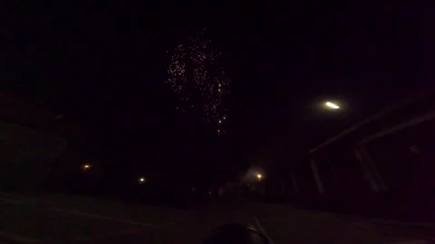 Fireworks display in a city during nighttime celebration with bright colors and  Stock Footage 335333617
