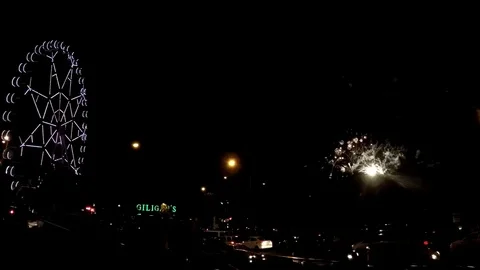 Fireworks display in dark evening in amusement park near huge ferris wheel Stock-Footage 81457730