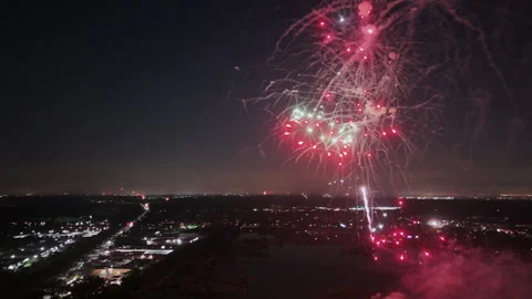 Fireworks display on dark sky at night. City lights on the horizon Stock Footage 279292546
