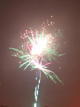 A fireworks display during the new year's Eve night lit up the night sky Stock Photos